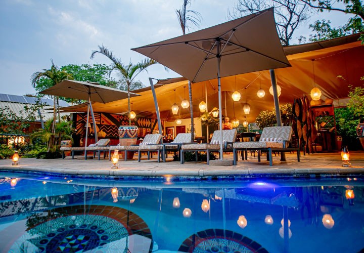 Lantern-lit pool terrace and loungers at Shongwe Lookout, Victoria Falls