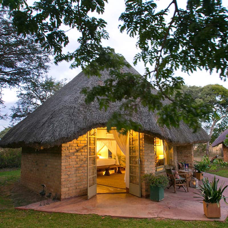 A thatched guest chalet at Imire Lodge